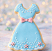 Cookie shaped like a blue dress with pink flowers and bow on a blurred background from a 4 inch Dress Metal Cookie Cutter