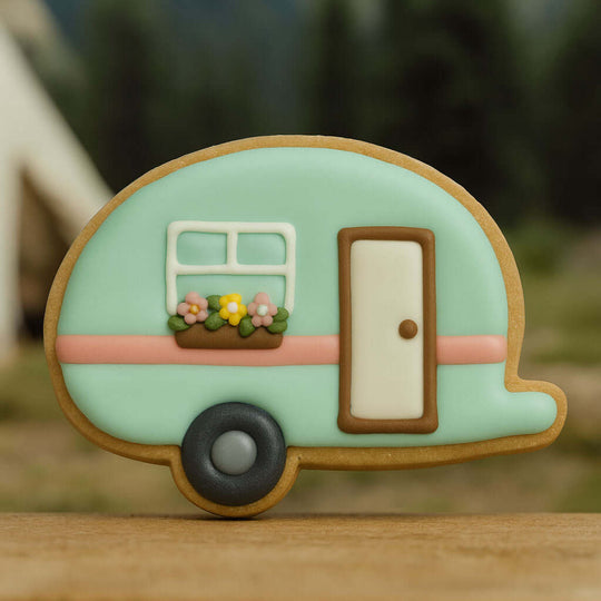Decorative cookie shaped like a camper with a door and window from a 4.5 inch Camper RV Metal Cookie Cutter