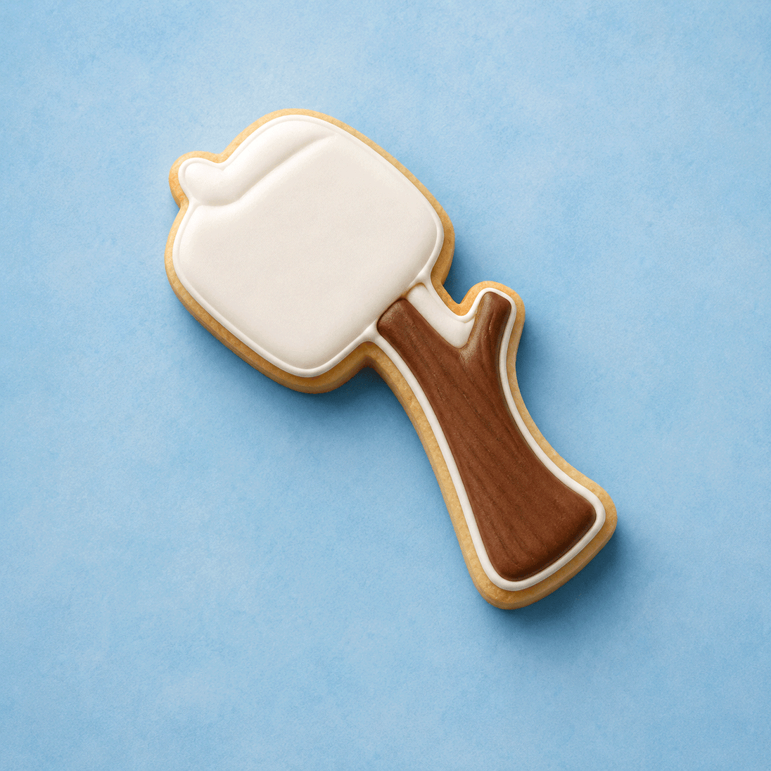 Cookie shaped like a marshmallow on a stick on a blue background from a 4 inch Marshmallow on a Stick Metal Cookie Cutter