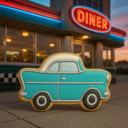 Vintage car-shaped cookie in front of a diner with a neon sign from a 4 inch Vintage Classic Car Metal Cookie Cutter