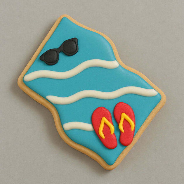Cookie with blue background, sunglasses, and red flip-flops on a gray background from a 4 inch Beach Towel Blanket Metal Cookie Cutter