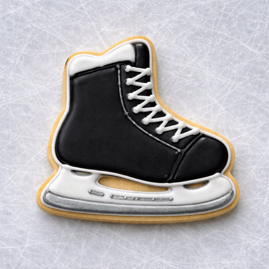 4 Inch Ice Skate Metal Cookie Cutter shaped black and white decorated cookie on an ice surface.