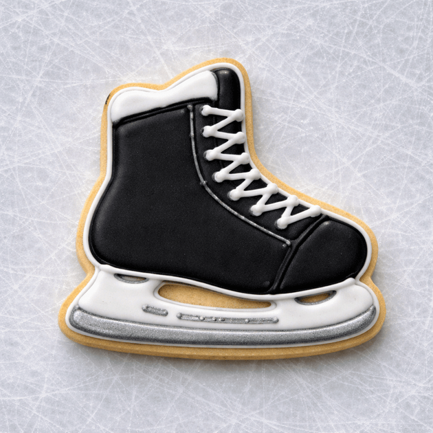 4 Inch Ice Skate Metal Cookie Cutter shaped black and white decorated cookie on an ice surface.