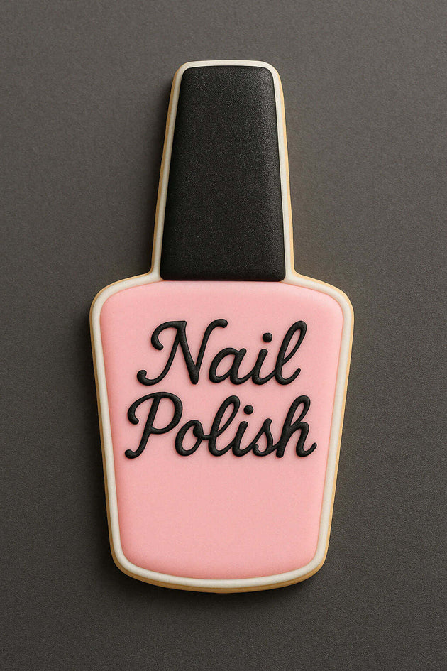 Cookie shaped like a nail polish bottle with 'Nail Polish' text on a dark background from a 4 inch Makeup Nail Polish Metal Cookie Cutter