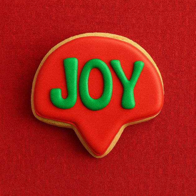 Red cookie with 'JOY' in green on a red background from a 3.5 inch Thought Bubble Shaped Metal Cookie Cutter