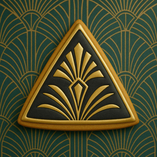 Decorative triangle emblem with gold and black design on a green background from a 3.5 inch Triangle Biscuit Metal Cookie Cutter