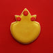 Gold cookie with red decorations on a red background from a 3.75 inch Pineapple Metal Cookie Cutter