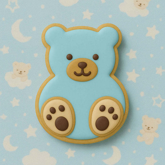 Blue teddy bear cookie on a light blue background with teddy bear pattern from a  3.5 inch Sitting Teddy Bear Metal Cookie Cutter