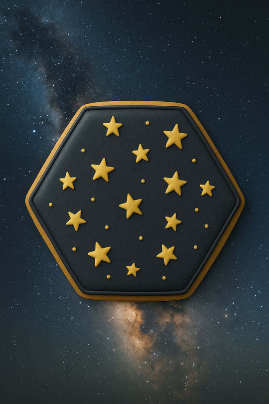 2.5 inch Hexagon Metal Cookie Cutter with gold star designs on a dark backdrop of a starry night sky.