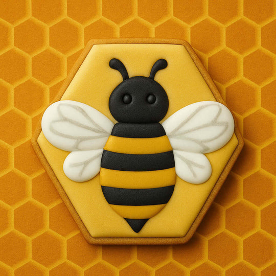 3 inch Hexagon Metal Cookie Cutter shaped like a bee with black and yellow icing on a honeycomb background.