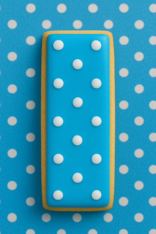 Blue cookie with white polka dots on a blue and white polka dot background