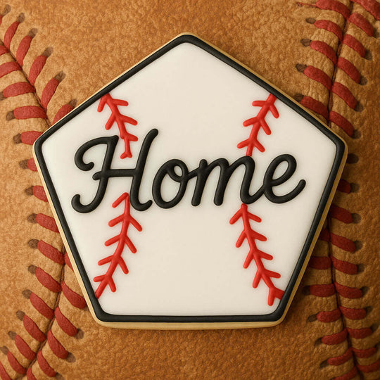 Pentagon shaped cookie with 'Home' text on a baseball field design, placed on a baseball from a 4 inch Pentagon Metal Cookie Cutter