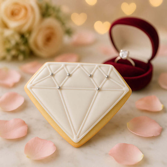 Diamond-shaped cookie with rose petals and a ring box in the background from a 4 inch Diamond Metal Cookie Cutter