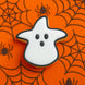 3.25 inch Candy Corn Witch Metal Cookie Cutter on an orange spider web background, perfect for Halloween baking.
