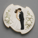 Decorative cookie with a bride and groom design on a gray background from a  4.75 inch Plaque or Frame Metal Cookie Cutter