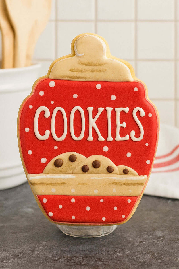 Cookie-shaped cookie jar with 'COOKIES' text on a kitchen counter from a 4 inch Cookie Jar Metal Cookie Cutter