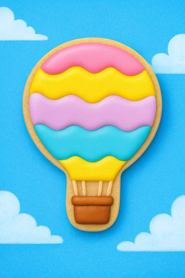 Colorful hot air balloon cookie on a blue background with clouds from a 5 inch Hot Air Balloon Metal Cookie Cutter