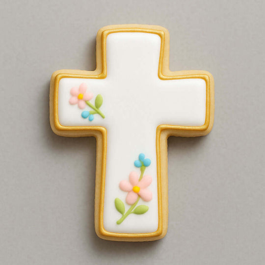 Decorative cross-shaped cookie with floral designs on a gray background from a 1.75 inch Mini Cross Metal Cookie Cutter