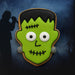 1.75 inch Mini Frankenstein Monster Metal Cookie Cutter shaped cookie decorated in green icing with white eyes.