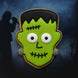 1.75 inch Mini Frankenstein Monster Metal Cookie Cutter shaped cookie decorated in green icing with white eyes.