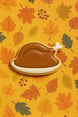 Cookie shaped like a roasted turkey on an autumn leaf pattern from a 2.25 inch Mini Turkey Dinner Metal Cookie Cutter