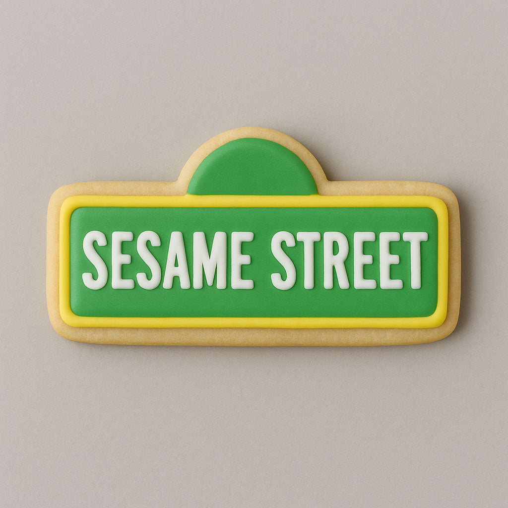Cookie shaped like a Sesame Street sign with green background and white text on a gray background from a 2.25 inch Mini Street Sign Metal Cookie Cutter