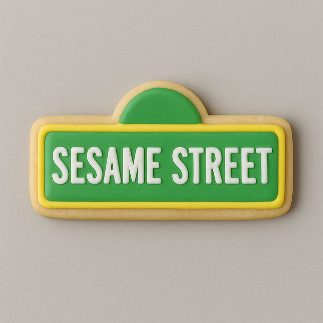 Cookie shaped like a Sesame Street sign with green background and white text on a gray background from a 2.25 inch Mini Street Sign Metal Cookie Cutter