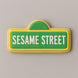 Cookie shaped like a Sesame Street sign with green background and white text on a gray background from a 2.25 inch Mini Street Sign Metal Cookie Cutter