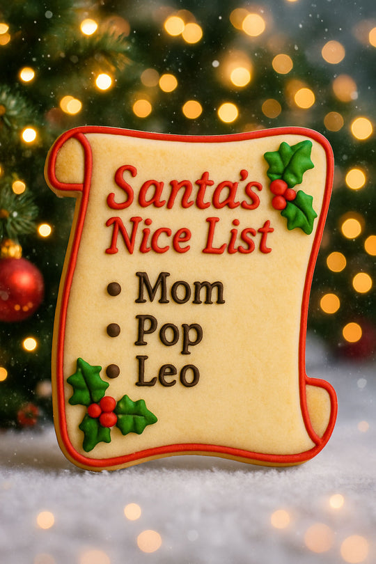 Decorative cookie shaped like a 'Santa's Nice List' with names on a festive background from a 2 inch Mini Naughty Nice Scroll Diploma Metal Cookie Cutter