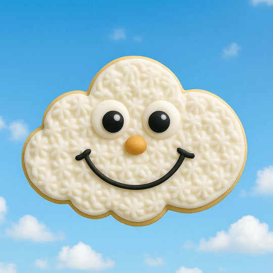 Cloud-shaped cookie with a face on a blue sky background from a 2 inch Mini Cloud Metal Cookie Cutter