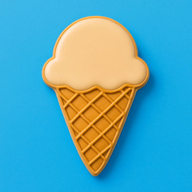 Ice cream cone-shaped cookie on a blue background from a 2 Inch Mini Ice Cream Cone Metal Cookie Cutter 