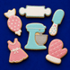 Decorative cookies shaped like kitchen utensils and a apron on a blue background from a Set of Baking Metal Cookie Cutters