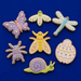 Decorative cookies shaped like insects and a snail on a blue background from a Set of Bugs Metal Cookie Cutters