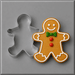 A 5 inch Gingerbread Boy Metal Cookie Cutter shown beside a decorated gingerbread man cookie on a smooth gray surface.