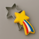 A 4 inch Shooting Star Metal Cookie Cutter with a decorated star-shaped cookie inside, shown on a smooth gray background.