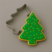 A sprinkled Christmas tree cookie and a 3.5 inch Christmas Tree Metal Cookie Cutter
