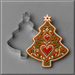 A 4 inch Tree with Star Metal Cookie Cutter shown beside a decorated gingerbread cookie in the same tree shape, on a smooth gray background.