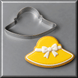 A 4.5 inch Easter Bonnet or Beach Hat Metal Cookie Cutter shown next to a decorated yellow sun hat cookie on a gray background.