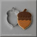 A 3 inch Acorn Metal Cookie Cutter shown next to a decorated acorn-shaped sugar cookie on a neutral gray background.