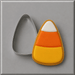 A decorated candy corn-shaped cookie with white, orange, and yellow icing sits next to a 3 inch Candy Corn Metal Cookie Cutter on a gray background.
