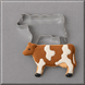 A brown and white cow cookie in front of a 4 inch Cow Metal Cookie Cutter