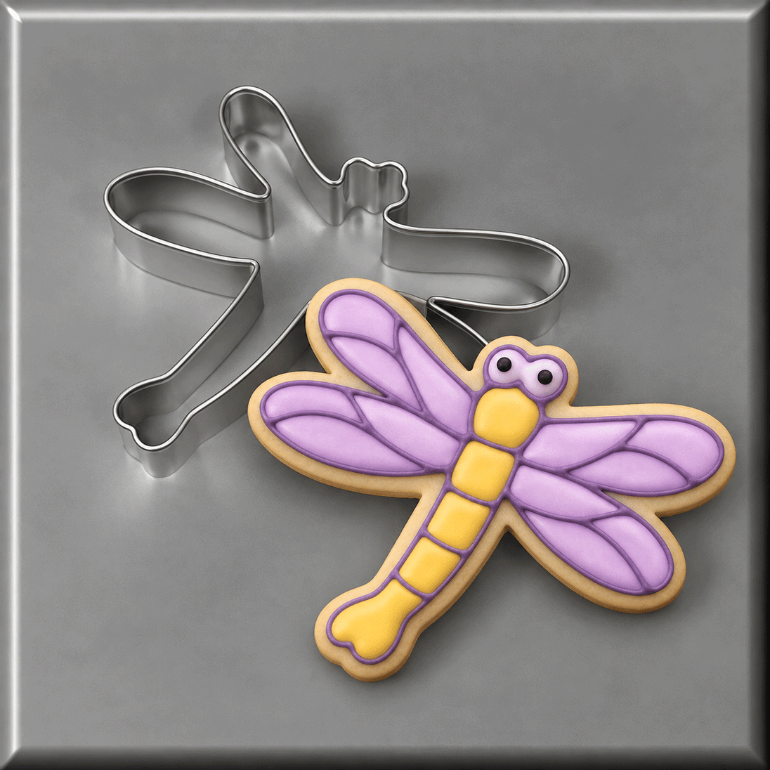 Purple and yellow dragonfly decorated cookie and a 3.5 inch Dragonfly Metal Cookie Cutter