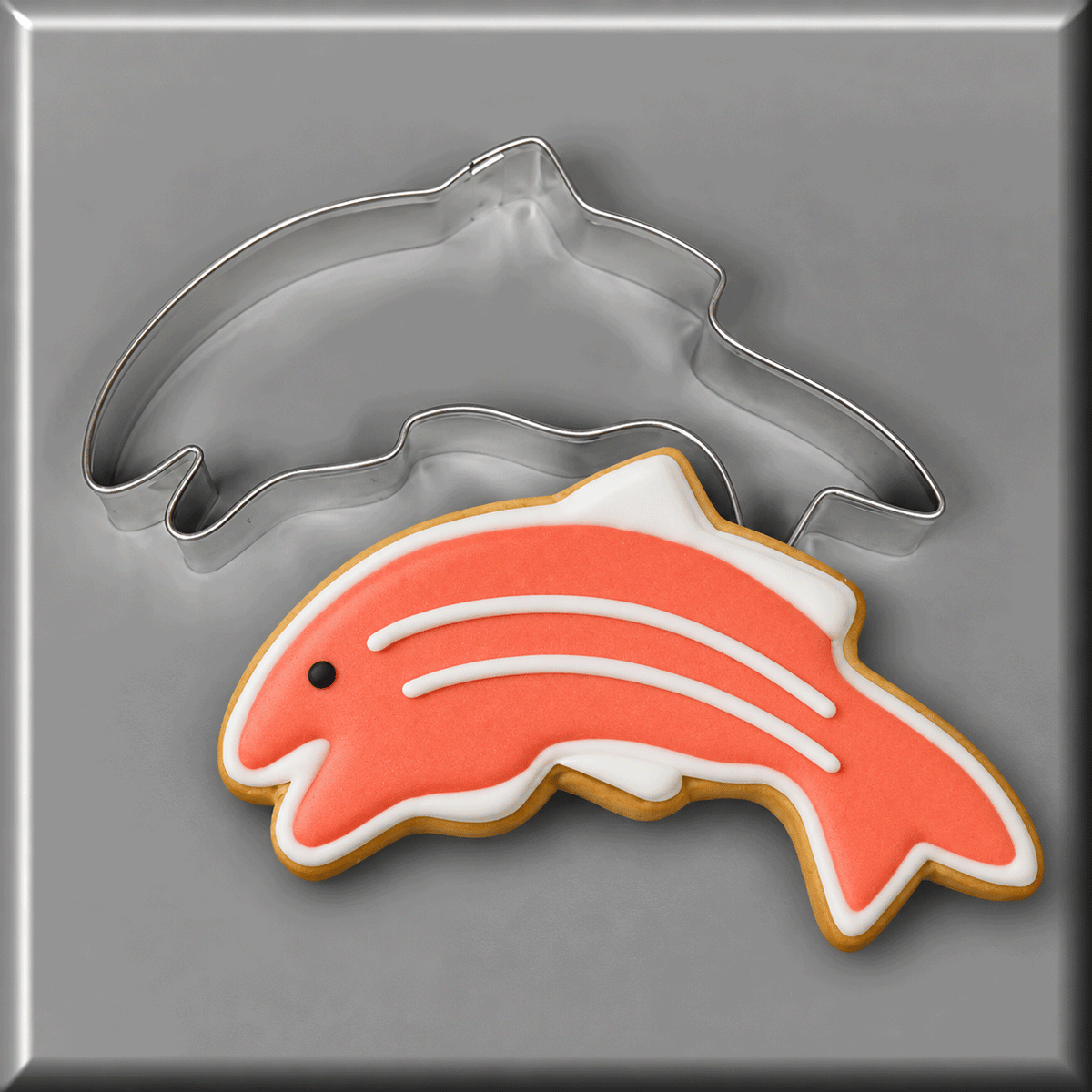 A salmon decorated cookie and a 5 inch Salmon Fish Metal Cookie Cutter