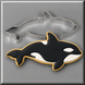 A black and white killer whale along side a 4 inch Killer Whale Metal Cookie Cutter