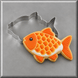 A decorated fish-shaped cookie in orange, yellow, and white, shown with a3 inch Fish Metal Cookie Cutter on a gray background.