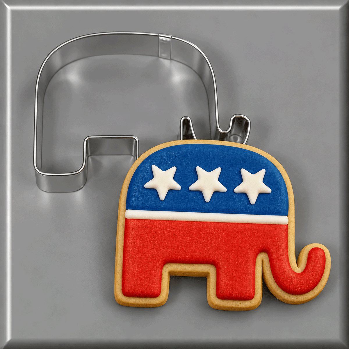 An elephant cookie decorated as a flag leaning against a 3.25 inch Elephant Metal Cookie Cutter