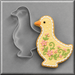 A 5 inch Goose Metal Cookie Cutter shown beside a decorated yellow goose-shaped cookie with pink flowers, green leaves, white icing dots, and an orange beak on a gray background.