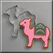 A pink camel cookie shown next to a 4 inch Camel Metal Cookie Cutter