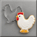A white hen cookie next to a 4 inch Chicken Hen Metal Cookie Cutter