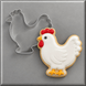 A white hen cookie next to a 4 inch Chicken Hen Metal Cookie Cutter